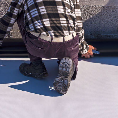 Roofer Installs a Flat Roof